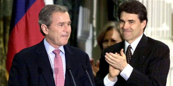 A teary-eyed President-elect George W. Bush (L) listens to applause after formally resigning as gove..