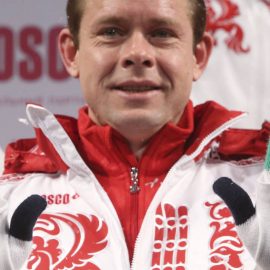 Former Russian ice-hockey player Bure shows a pair of gloves during a presentation of Russia's uniform for the Sochi 2014 Winter Olympics in Moscow