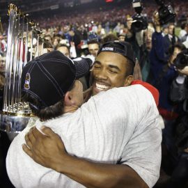 Tim Salmon hugs Garret Anderson after winning the World Series
