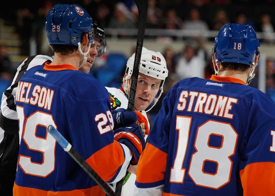 UNIONDALE, NY - JANUARY 02: Bryan Bickell #29 of the Chicago Blackhawks eyes Brock Nelson #29 and Ryan Strome #18 of the New York Islanders following a brief battle during the third period at the Nassau Veterans Memorial Coliseum on January 2, 2014 in Uniondale, New York. The Islanders defeated the Blackhawks 3-2 in overtime. (Photo by Bruce Bennett/Getty Images)