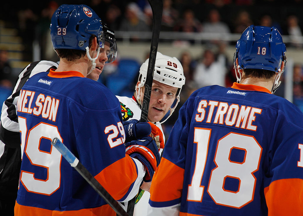 UNIONDALE, NY - JANUARY 02: Bryan Bickell #29 of the Chicago Blackhawks eyes Brock Nelson #29 and Ryan Strome #18 of the New York Islanders following a brief battle during the third period at the Nassau Veterans Memorial Coliseum on January 2, 2014 in Uniondale, New York. The Islanders defeated the Blackhawks 3-2 in overtime. (Photo by Bruce Bennett/Getty Images)