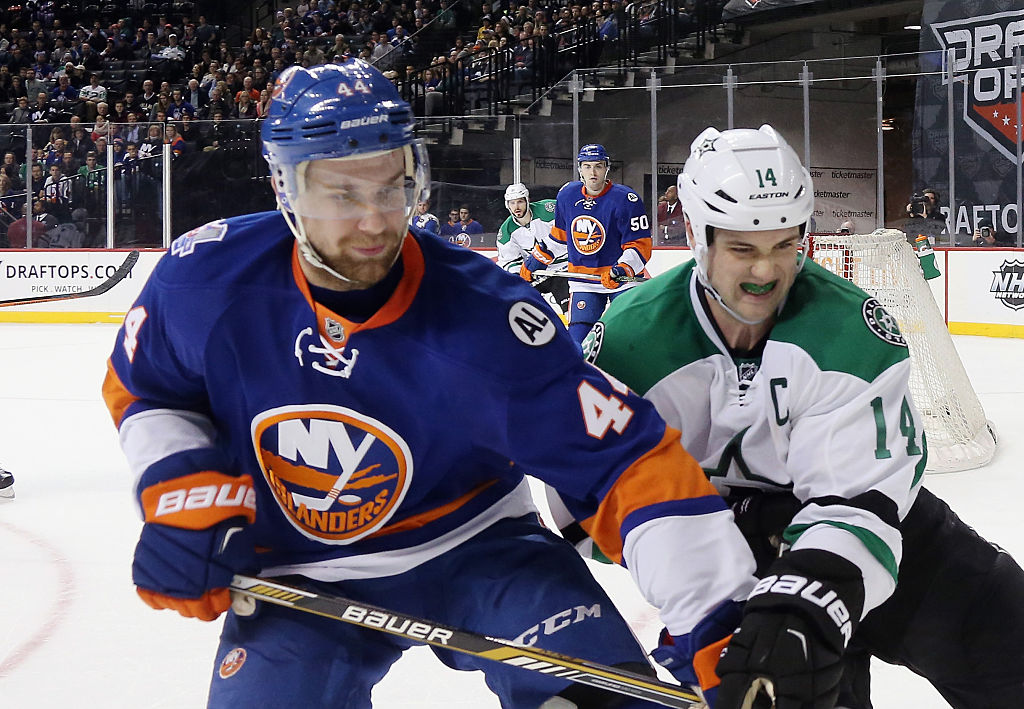 NEW YORK, NY - JANUARY 03: Calvin de Haan #44 of the New York Islanders fends off Jamie Benn #14 of the Dallas Stars skates against the New York Islanders at the Barclays Center on January 3, 2016 in the Brooklyn borough of New York City. The Islanders defeated the Stars 6-5. (Photo by Bruce Bennett/Getty Images)