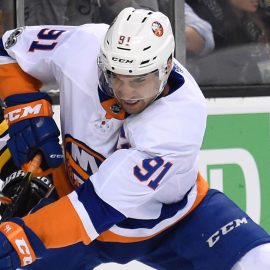 Dec 9, 2017; Boston, MA, USA; New York Islanders center John Tavares (91) battles for the puck with Boston Bruins defenseman Kevan Miller (86) during the second period at TD Garden. Mandatory Credit: Bob DeChiara-USA TODAY Sports