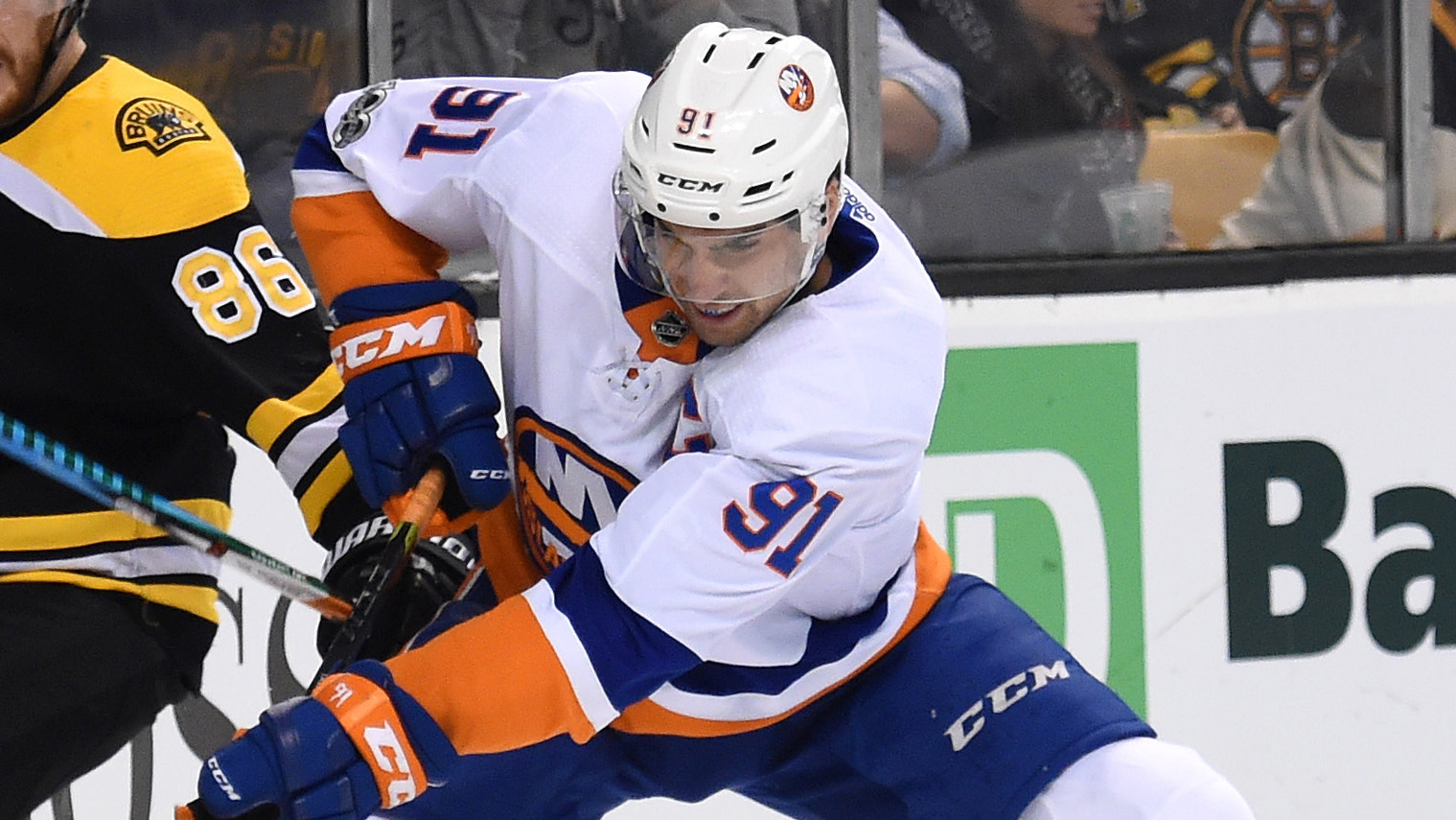 Dec 9, 2017; Boston, MA, USA; New York Islanders center John Tavares (91) battles for the puck with Boston Bruins defenseman Kevan Miller (86) during the second period at TD Garden. Mandatory Credit: Bob DeChiara-USA TODAY Sports