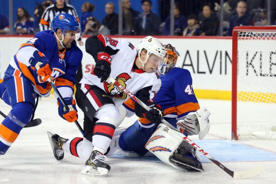 Dec 1, 2017; Brooklyn, NY, USA; Ottawa Senators center Ryan Dzingel (18) scores the game winning goal against New York Islanders goalie Jaroslav Halak (41) in front of Islanders defenseman Dennis Seidenberg (4) during the third period at Barclays Center. Mandatory Credit: Brad Penner-USA TODAY Sports