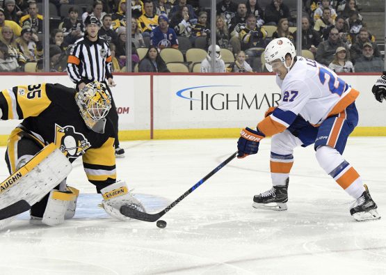 Dec 7, 2017; Pittsburgh, PA, USA;Pittsburgh Penguins goalie Tristan Jarry (35) makes a save against New York Islanders left wing Anders Lee (27) during the first period of an NHL hockey game at PPG PAINTS Arena. Mandatory Credit: Don Wright-USA TODAY Sports