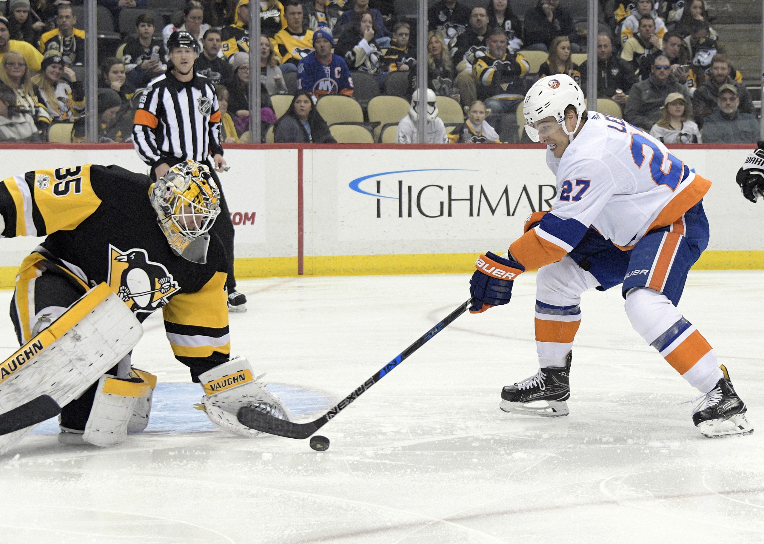 Dec 7, 2017; Pittsburgh, PA, USA;Pittsburgh Penguins goalie Tristan Jarry (35) makes a save against New York Islanders left wing Anders Lee (27) during the first period of an NHL hockey game at PPG PAINTS Arena. Mandatory Credit: Don Wright-USA TODAY Sports
