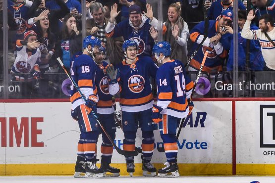 Dec 23, 2017; Brooklyn, NY, USA; New York Islanders center Mathew Barzal (13) celebrates his first hat trick during the third period between the New York Islanders and the Winnipeg Jets at Barclays Center. Mandatory Credit: Dennis Schneidler-USA TODAY Sports