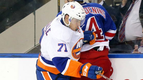 Sep 27, 2016; New York, NY, USA; New York Rangers defenseman Adam Clendening (4) and New York Islanders left wing Michael Dal Colle (71) come together at the boards during the second period during a preseason hockey game at Madison Square Garden. Mandatory Credit: Andy Marlin-USA TODAY Sports