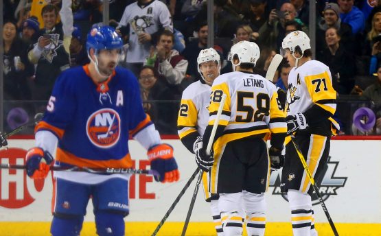 Jan 5, 2018; Brooklyn, NY, USA; Pittsburgh Penguins center Evgeni Malkin (71) is congratulated after scoring a goal as New York Islanders right wing Cal Clutterbuck (15) skates away during the second period at Barclays Center. Mandatory Credit: Andy Marlin-USA TODAY Sports