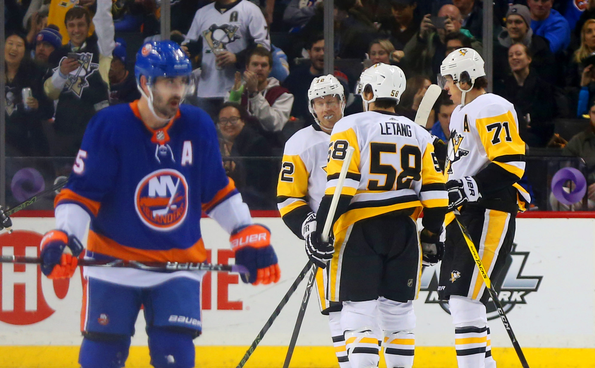 Jan 5, 2018; Brooklyn, NY, USA; Pittsburgh Penguins center Evgeni Malkin (71) is congratulated after scoring a goal as New York Islanders right wing Cal Clutterbuck (15) skates away during the second period at Barclays Center. Mandatory Credit: Andy Marlin-USA TODAY Sports