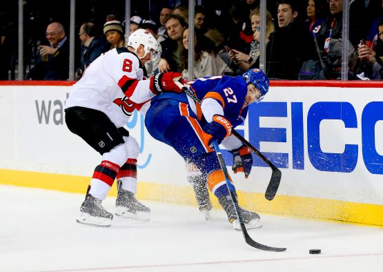 Jan 16, 2018; Brooklyn, NY, USA; New Jersey Devils defenseman Andy Greene (6) and New York Islanders left wing Anders Lee (27) battle for a loose puck during the second period at Barclays Center. Mandatory Credit: Andy Marlin-USA TODAY Sports