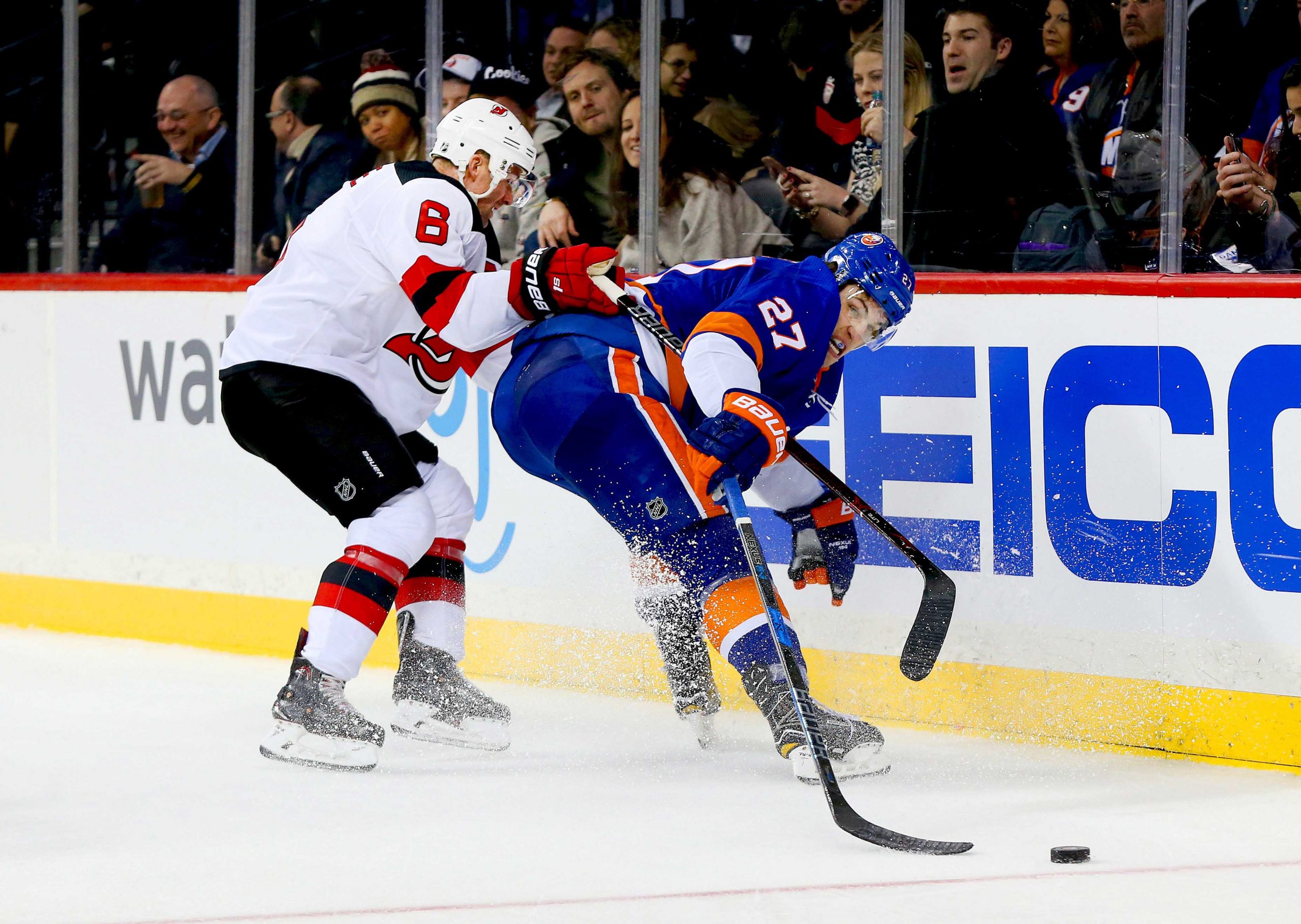 Jan 16, 2018; Brooklyn, NY, USA; New Jersey Devils defenseman Andy Greene (6) and New York Islanders left wing Anders Lee (27) battle for a loose puck during the second period at Barclays Center. Mandatory Credit: Andy Marlin-USA TODAY Sports