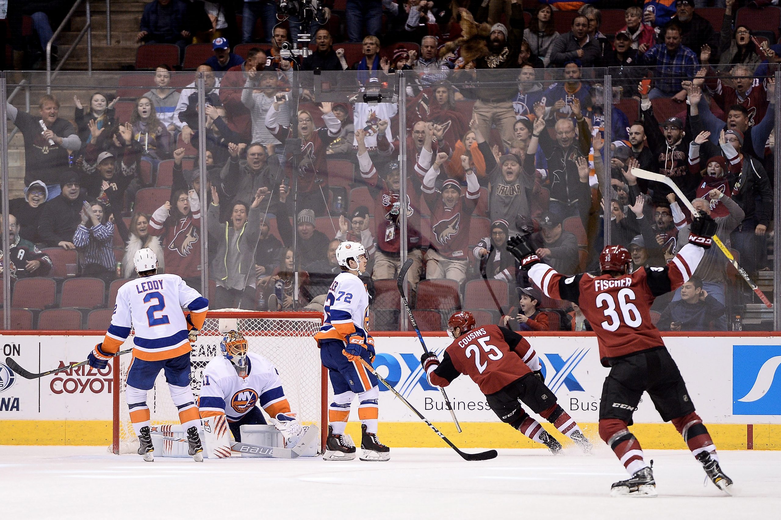 Jan 22, 2018; Glendale, AZ, USA; Arizona Coyotes center Nick Cousins (25) scores the game winning goal against New York Islanders goaltender Jaroslav Halak (41) in overtime at Gila River Arena. The Arizona Coyotes won 3-2 in overtime. Mandatory Credit: Jennifer Stewart-USA TODAY Sports