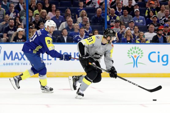Jan 28, 2018; Tampa, FL, USA; Atlantic Division forward Steven Stamkos (91) of the Tampa Bay Lightning reaches for the puck on Metropolitan Division forward John Tavares (91) of the New York Islanders during the 2018 NHL All Star Game at Amalie Arena. Mandatory Credit: Kim Klement-USA TODAY Sports
