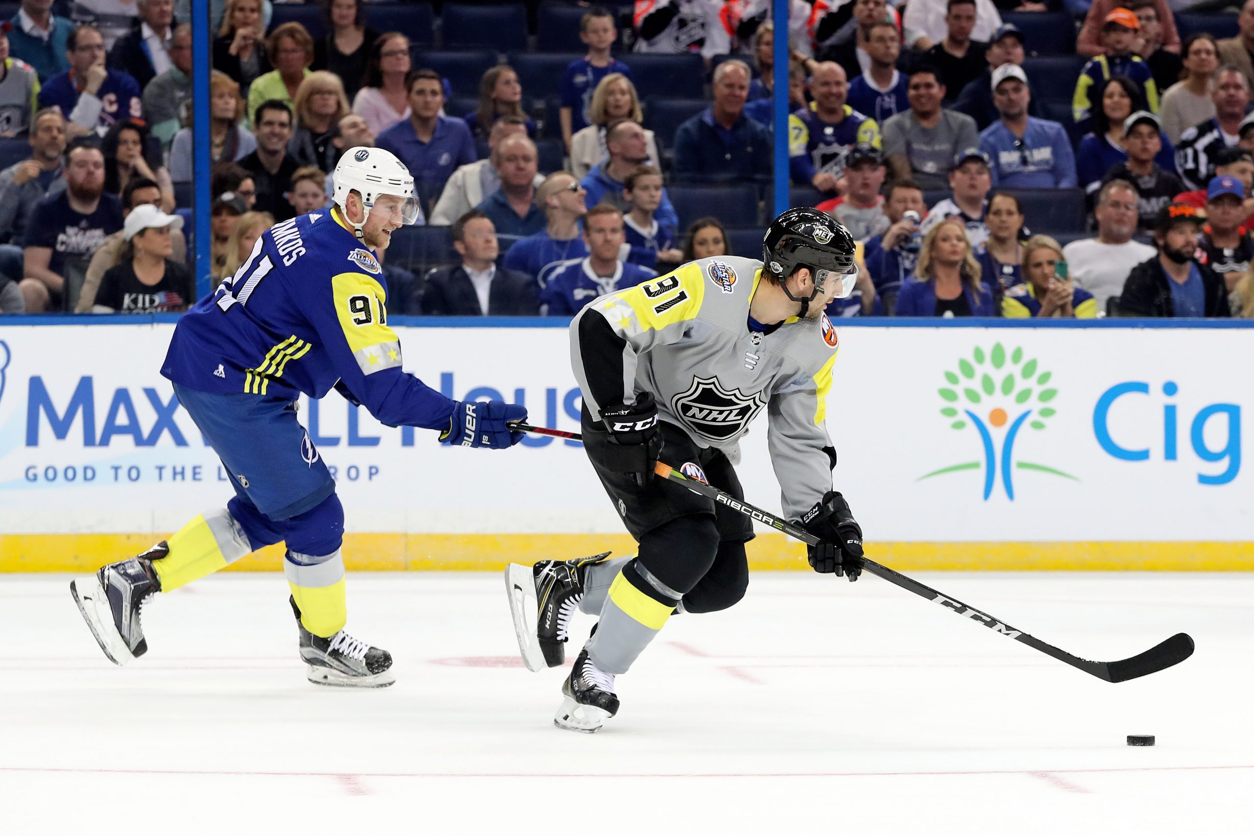 Jan 28, 2018; Tampa, FL, USA; Atlantic Division forward Steven Stamkos (91) of the Tampa Bay Lightning reaches for the puck on Metropolitan Division forward John Tavares (91) of the New York Islanders during the 2018 NHL All Star Game at Amalie Arena. Mandatory Credit: Kim Klement-USA TODAY Sports