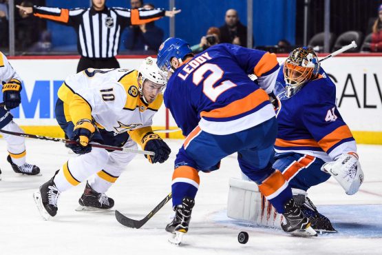 Feb 5, 2018; Brooklyn, NY, USA; New York Islanders goaltender Jaroslav Halak (41) makes a save and Nashville Predators center Colton Sissons (10) and New York Islanders defenseman Nick Leddy (2) fight over the loose puck during the first period at Barclays Center. Mandatory Credit: Dennis Schneidler-USA TODAY Sports