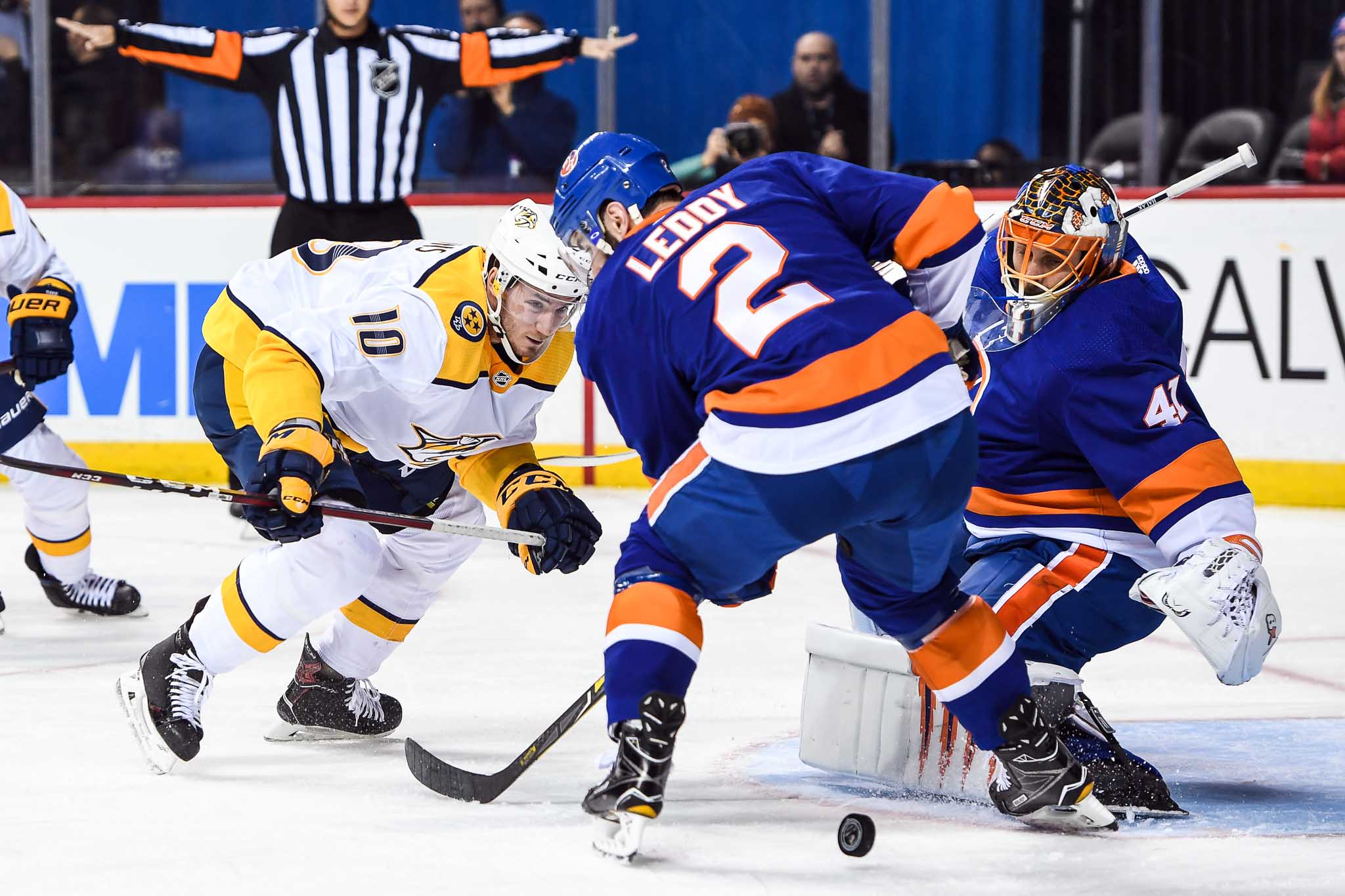 Feb 5, 2018; Brooklyn, NY, USA; New York Islanders goaltender Jaroslav Halak (41) makes a save and Nashville Predators center Colton Sissons (10) and New York Islanders defenseman Nick Leddy (2) fight over the loose puck during the first period at Barclays Center. Mandatory Credit: Dennis Schneidler-USA TODAY Sports