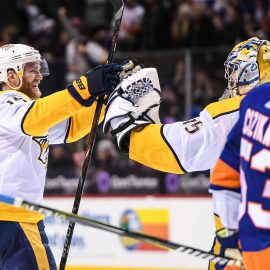 Feb 5, 2018; Brooklyn, NY, USA; Nashville Predators defenseman Ryan Ellis (4) and goaltender Pekka Rinne (35) celebrate the win against the New York Islanders during the overtime period at Barclays Center. Mandatory Credit: Dennis Schneidler-USA TODAY Sports
