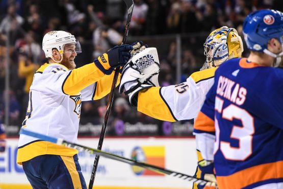 Feb 5, 2018; Brooklyn, NY, USA; Nashville Predators defenseman Ryan Ellis (4) and goaltender Pekka Rinne (35) celebrate the win against the New York Islanders during the overtime period at Barclays Center. Mandatory Credit: Dennis Schneidler-USA TODAY Sports