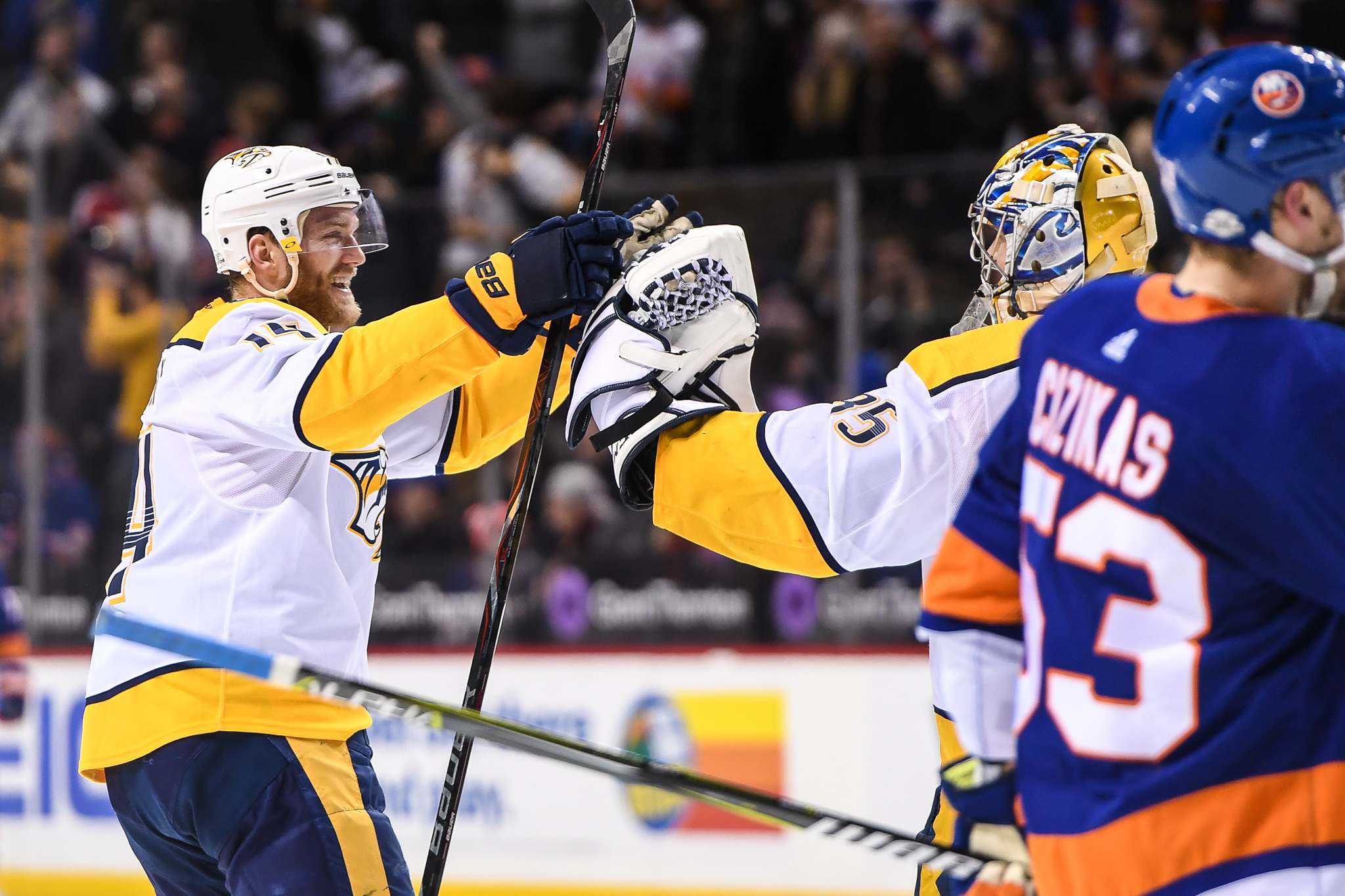 Feb 5, 2018; Brooklyn, NY, USA; Nashville Predators defenseman Ryan Ellis (4) and goaltender Pekka Rinne (35) celebrate the win against the New York Islanders during the overtime period at Barclays Center. Mandatory Credit: Dennis Schneidler-USA TODAY Sports