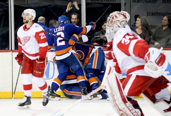 Feb 9, 2018; Brooklyn, NY, USA; New York Islanders center Brock Nelson (29) is congratulated after scoring the game winning goal in overtime as Detroit Red Wings goaltender Petr Mrazek (34) and defenseman Mike Green (25) skate away at Barclays Center. Mandatory Credit: Andy Marlin-USA TODAY Sports