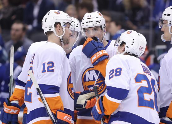 Feb 22, 2018; Toronto, Ontario, CAN; New York Islanders center John Tavares (91) talks to right wing Josh Bailey (12) against the Toronto Maple Leafs at Air Canada Centre. The Maple Leafs beat the Islanders 4-3 in a shootout. Mandatory Credit: Tom Szczerbowski-USA TODAY Sports