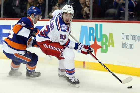 Feb 16, 2017; Brooklyn, NY, USA; New York Rangers center Mika Zibanejad (93) plays the puck against New York Islanders defenseman Thomas Hickey (14) during the third period at Barclays Center. Mandatory Credit: Brad Penner-USA TODAY Sports