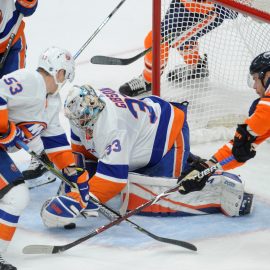 Mar 8, 2018; Edmonton, Alberta, CAN; New York Islanders goalie Christopher Gibson (33) battles for the puck with Islanders center Casey Cizikas (53) and Islanders defenceman Johnny Boychuck (55) helps as Edmonton Oilers right winger Iiro Pakarinen (26) skates towards them during the first period at Rogers Place. Mandatory Credit: Walter Tychnowicz-USA TODAY Sports