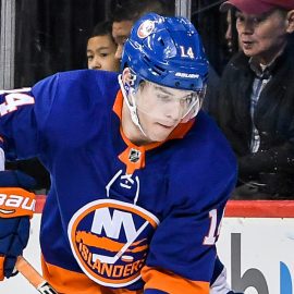 Mar 20, 2018; Brooklyn, NY, USA; New York Islanders defenseman Thomas Hickey (14) and Pittsburgh Penguins right wing Bryan Rust (17) battle for the puck behind the goal during the third period at Barclays Center. Mandatory Credit: Dennis Schneidler-USA TODAY Sports