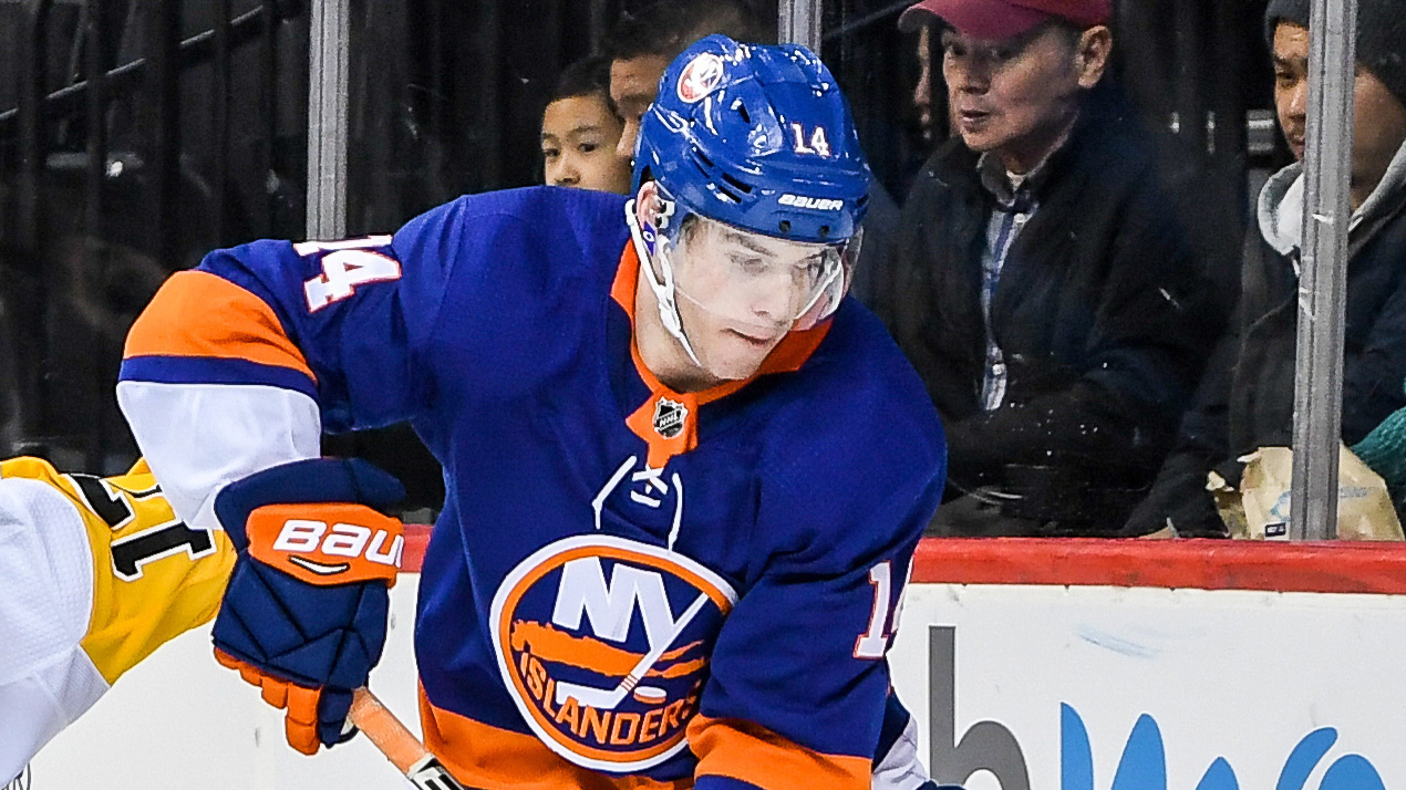 Mar 20, 2018; Brooklyn, NY, USA; New York Islanders defenseman Thomas Hickey (14) and Pittsburgh Penguins right wing Bryan Rust (17) battle for the puck behind the goal during the third period at Barclays Center. Mandatory Credit: Dennis Schneidler-USA TODAY Sports