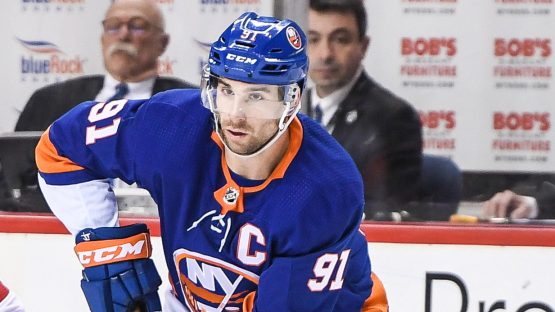 Mar 2, 2018; Brooklyn, NY, USA; New York Islanders center John Tavares (91) skates with the puck defended by Montreal Canadiens right wing Andrew Shaw (65) during the third period at Barclays Center. Mandatory Credit: Dennis Schneidler-USA TODAY Sports