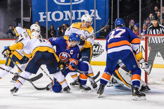 Feb 5, 2018; Brooklyn, NY, USA; Nashville Predators goaltender Pekka Rinne (35) makes a save as Nashville Predators defenseman Roman Josi (59) attempts to stop New York Islanders center John Tavares (91) from putting in a rebound during the second period at Barclays Center. Mandatory Credit: Dennis Schneidler-USA TODAY Sports