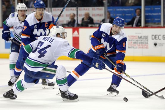 Nov 13, 2018; Brooklyn, NY, USA; New York Islanders defenseman Nick Leddy (2) plays the puck against Vancouver Canucks center Tyler Motte (64) during the second period at Barclays Center. Mandatory Credit: Brad Penner-USA TODAY Sports