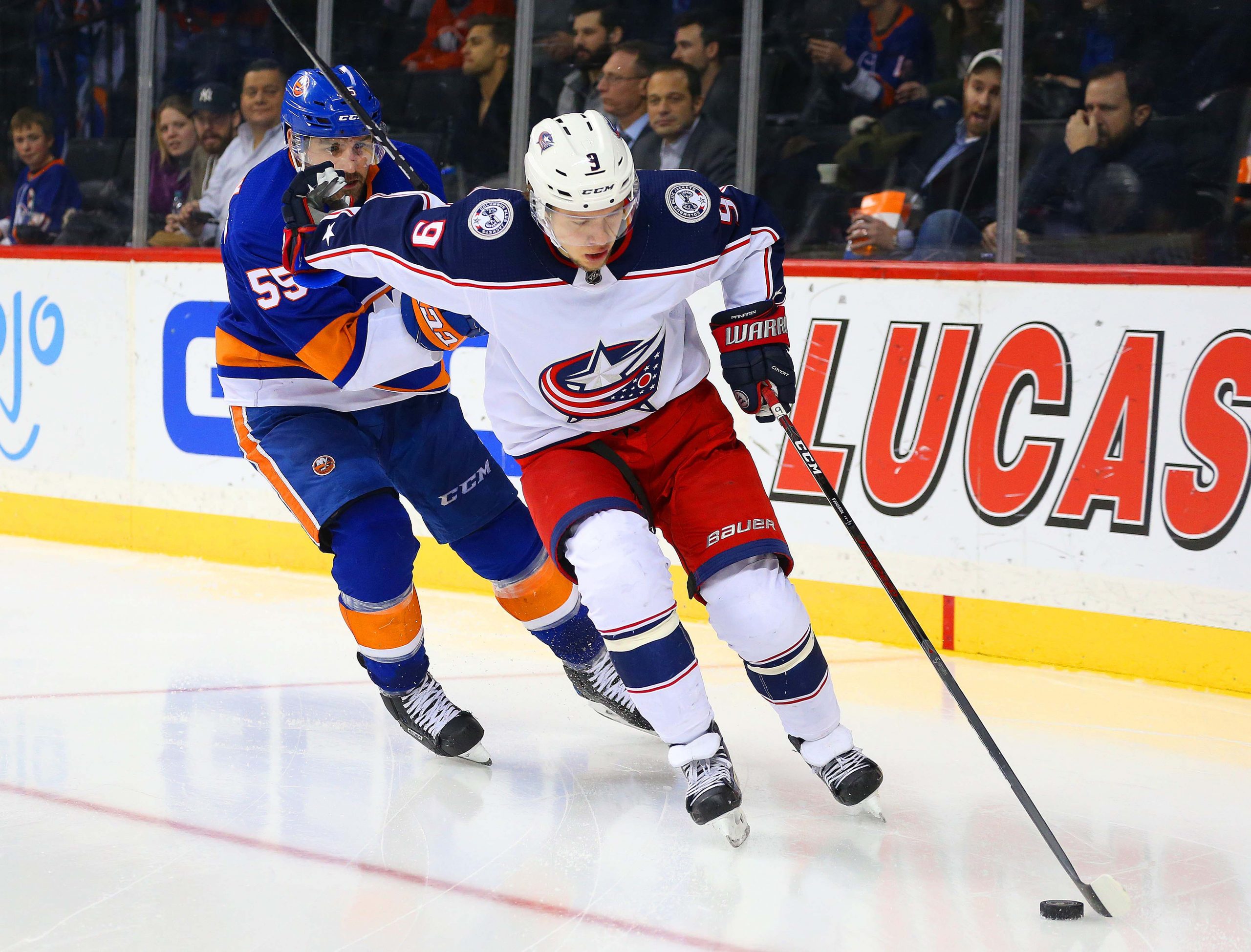 Feb 13, 2018; Brooklyn, NY, USA; Columbus Blue Jackets left wing Artemi Panarin (9) and New York Islanders defenseman Johnny Boychuk (55) pursue a loose puck during the third period at Barclays Center. Mandatory Credit: Andy Marlin-USA TODAY Sports