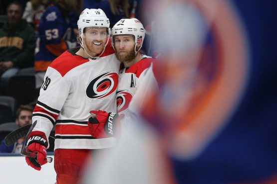 Jan 8, 2019; Uniondale, NY, USA; Carolina Hurricanes defenseman Jaccob Slavin (74) celebrates with defenseman Dougie Hamilton (19) after scoring the go ahead goal against the New York Islanders during the third period at Nassau Veterans Memorial Coliseum. Mandatory Credit: Brad Penner-USA TODAY Sports
