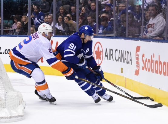Dec 29, 2018; Toronto, Ontario, CAN; Toronto Maple Leafs forward John Tavares (91) battles for the puck against New York Islanders defenseman Nick Leddy (2) in the second period at Scotiabank Arena. Mandatory Credit: Dan Hamilton-USA TODAY Sports