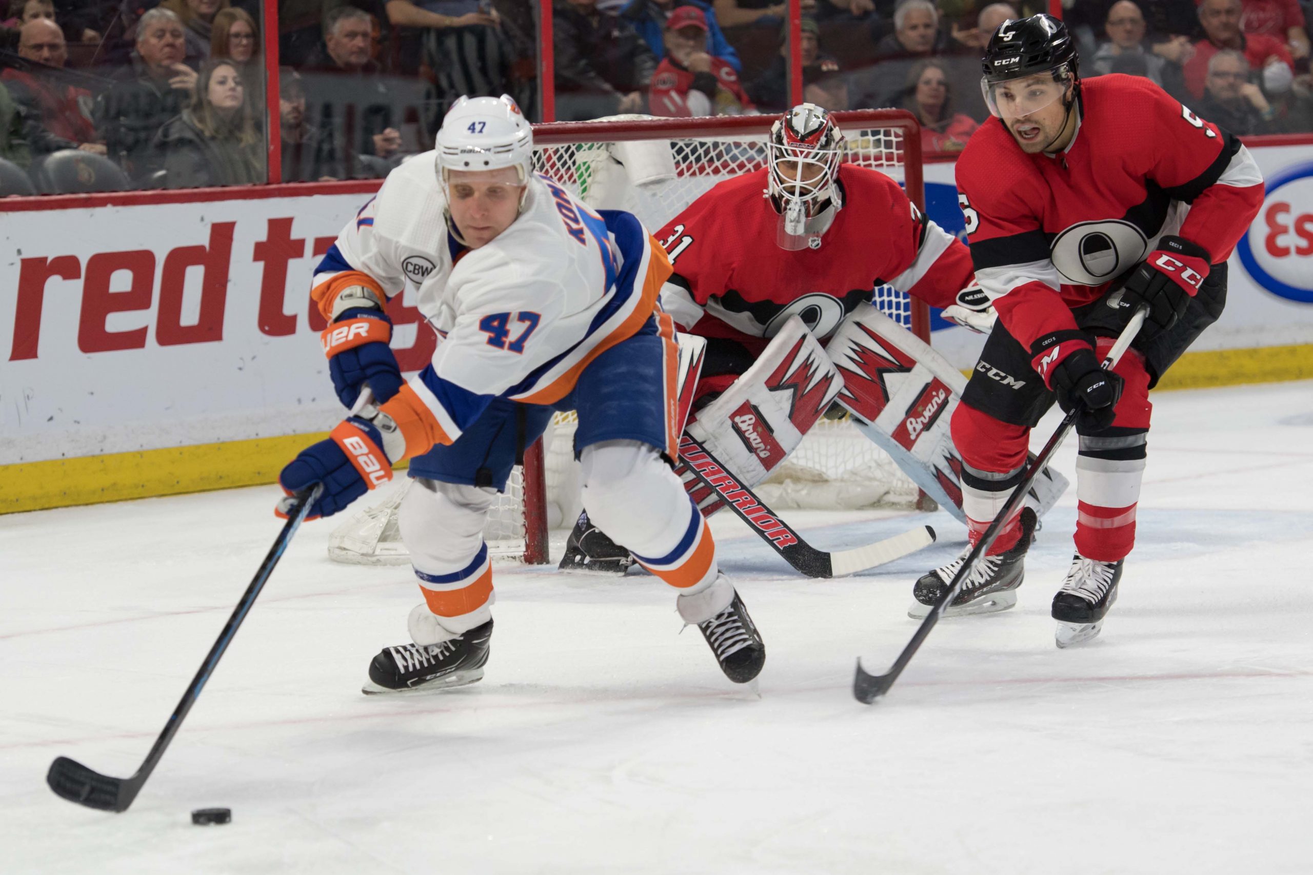 Mar 7, 2019; Ottawa, Ontario, CAN; New York Islanders right wing Leo Komarov (47) skates with the puck in front of Ottawa Senators defenseman Cody Ceci (5) in the first period at the Canadian Tire Centre. Mandatory Credit: Marc DesRosiers-USA TODAY Sports