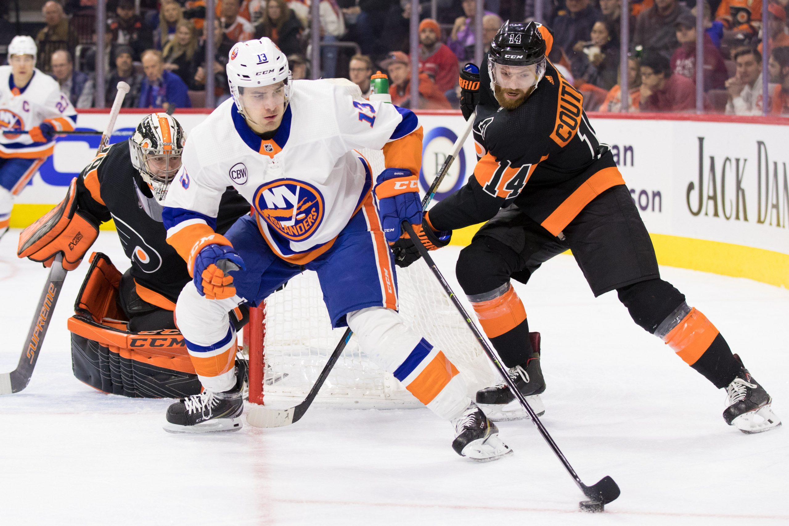Mar 23, 2019; Philadelphia, PA, USA; New York Islanders center Mathew Barzal (13) skates with the puck in front of Philadelphia Flyers center Sean Couturier (14) and goaltender Carter Hart (79) during the second period at Wells Fargo Center. Mandatory Credit: Bill Streicher-USA TODAY Sports