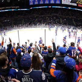 Dec 1, 2018; Uniondale, NY, USA; New York Islanders right wing Cal Clutterbuck (15) tosses a puck to fans during warmups before a game against the Columbus Blue Jackets at Nassau Veterans Memorial Coliseum. Mandatory Credit: Brad Penner-USA TODAY Sports