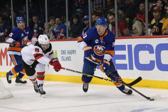 Nov 3, 2018; Brooklyn, NY, USA; New York Islanders center Casey Cizikas (53) plays the puck against New Jersey Devils defenseman Will Butcher (8) during the second period at Barclays Center. Mandatory Credit: Brad Penner-USA TODAY Sports