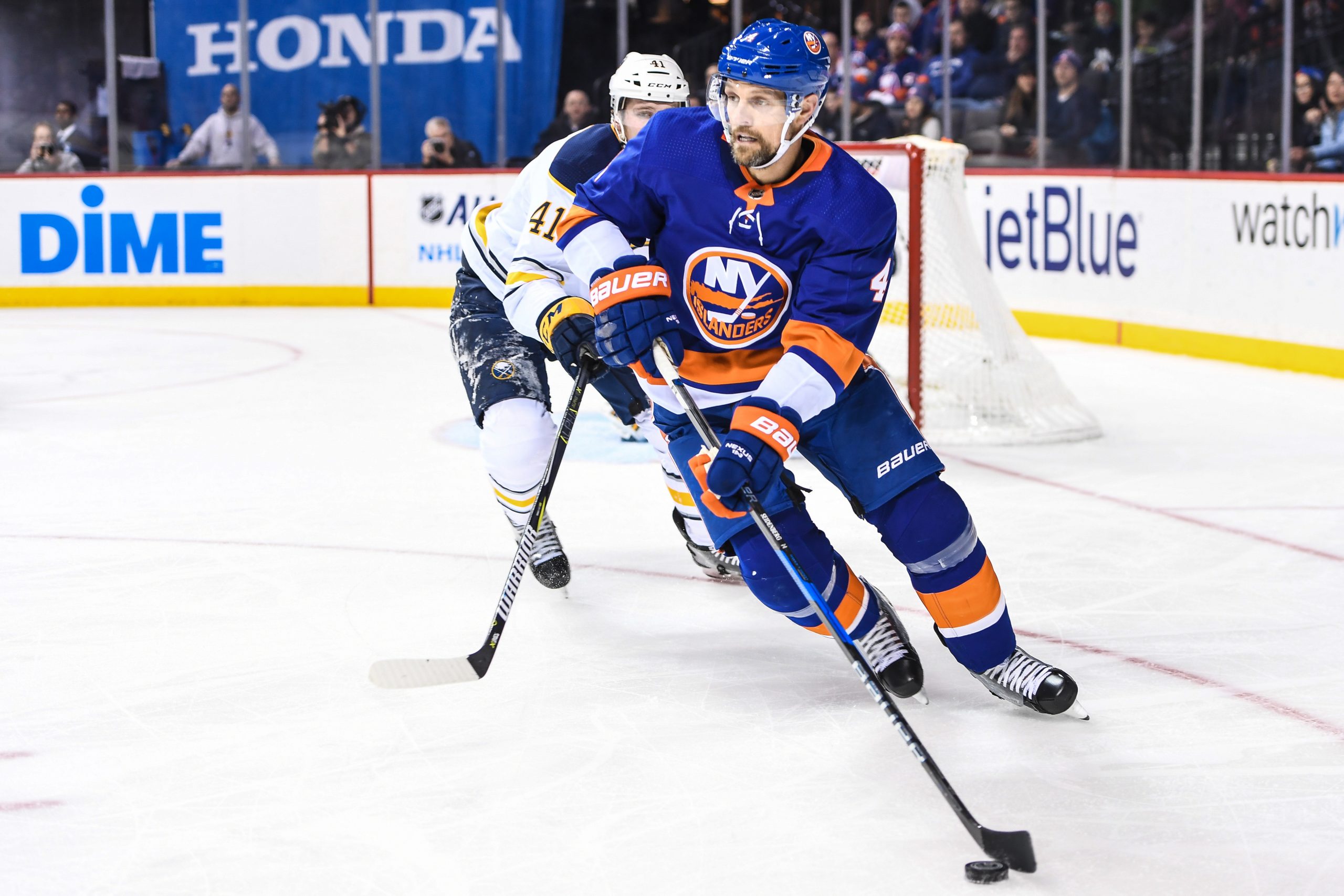 Dec 27, 2017; Brooklyn, NY, USA; New York Islanders defenseman Dennis Seidenberg (4) looks to make a pass defended by Buffalo Sabres defenseman Justin Falk (41) during the second period go the game between the New York Islanders and the Buffalo Sabres at Barclays Center. Mandatory Credit: Dennis Schneidler-USA TODAY Sports