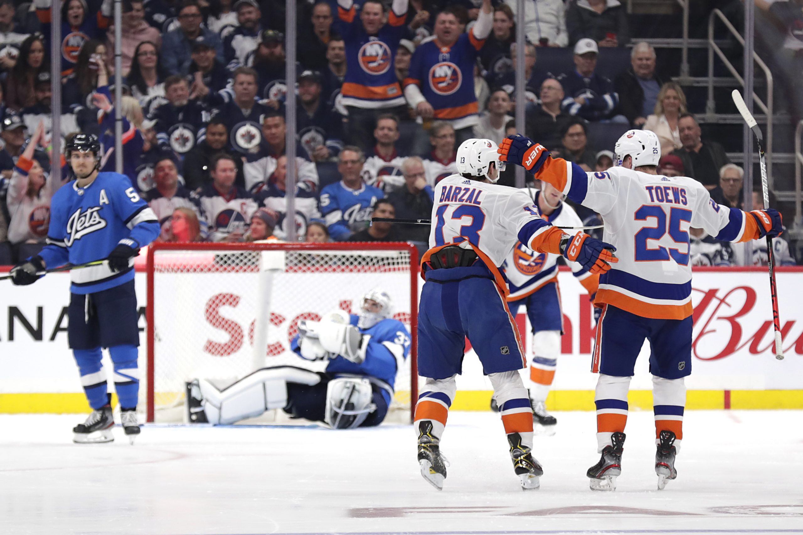 Oct 17, 2019; Winnipeg, Manitoba, CAN; New York Islanders center Mathew Barzal (13) celebrates his second period goal against the Winnipeg Jets at Bell MTS Place. Mandatory Credit: James Carey Lauder-USA TODAY Sports