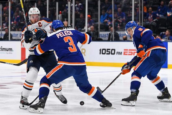 Oct 8, 2019; Uniondale, NY, USA; New York Islanders defenseman Adam Pelech (3) pushes Edmonton Oilers center Connor McDavid (97) off the puck during the third period at Nassau Veterans Memorial Coliseum. Mandatory Credit: Dennis Schneidler-USA TODAY Sports