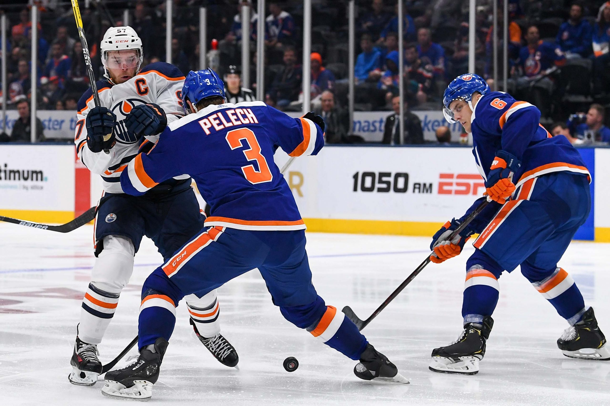 Oct 8, 2019; Uniondale, NY, USA; New York Islanders defenseman Adam Pelech (3) pushes Edmonton Oilers center Connor McDavid (97) off the puck during the third period at Nassau Veterans Memorial Coliseum. Mandatory Credit: Dennis Schneidler-USA TODAY Sports