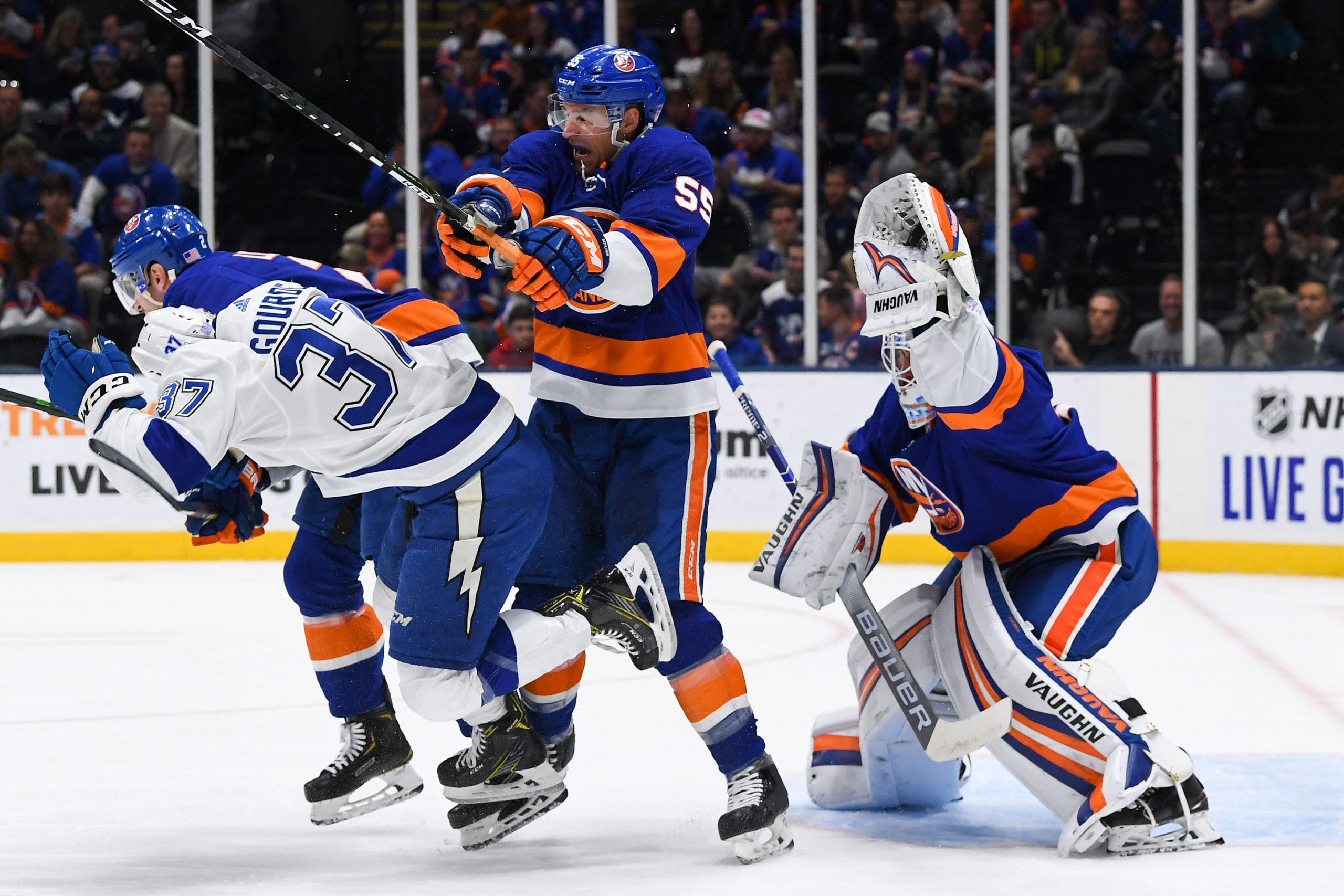 Nov 1, 2019; Uniondale, NY, USA; New York Islanders goaltender Thomas Greiss (1) makes a glove save behind New York Islanders defenseman Johnny Boychuk (55) and Tampa Bay Lightning center Yanni Gourde (37) during the first period at Nassau Veterans Memorial Coliseum. Mandatory Credit: Dennis Schneidler-USA TODAY Sports