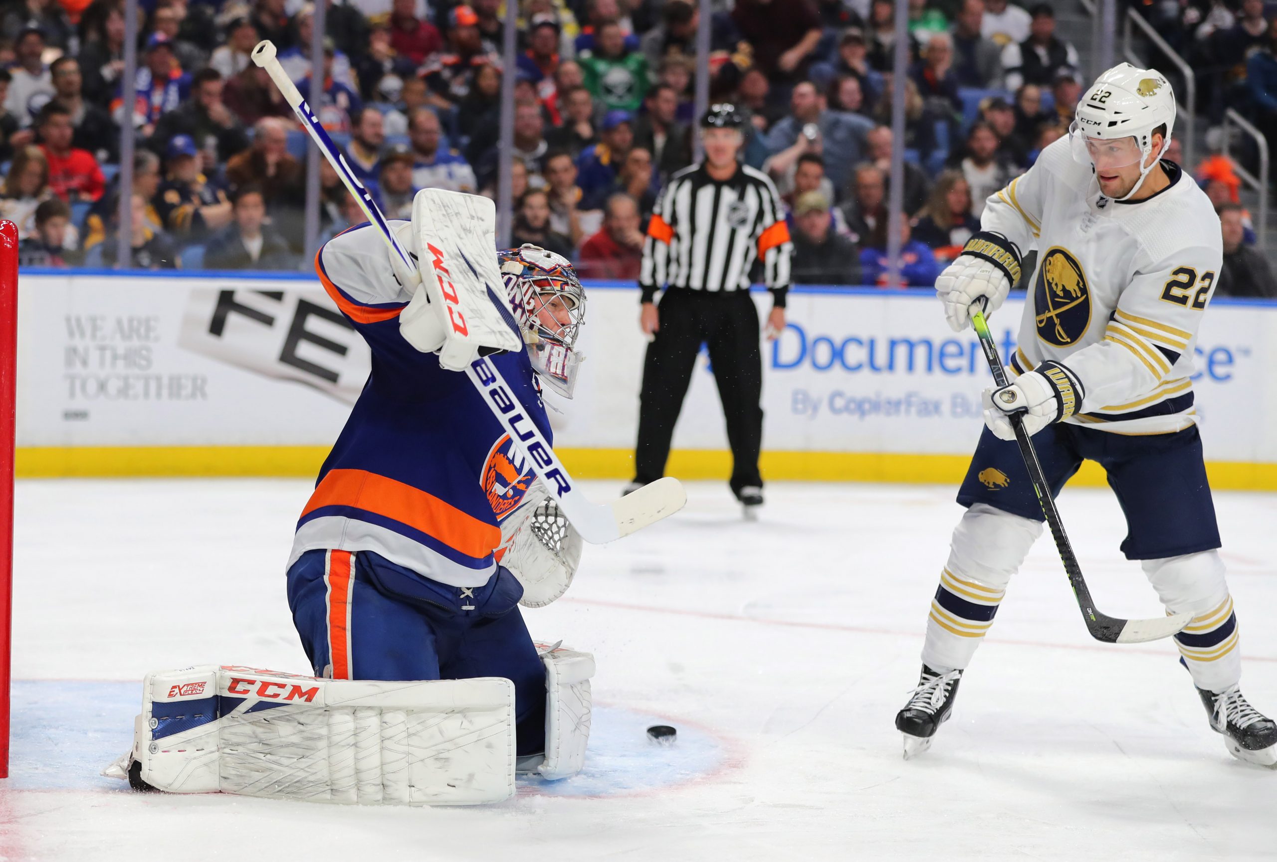 Nov 2, 2019; Buffalo, NY, USA; Buffalo Sabres left wing Johan Larsson (22) deflects a shot on New York Islanders goaltender Semyon Varlamov (40) during the second period at KeyBank Center. Mandatory Credit: Timothy T. Ludwig-USA TODAY Sports
