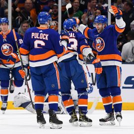 Nov 13, 2019; Uniondale, NY, USA; New York Islanders center Derick Brassard (10) celebrates with center Mathew Barzal (13) and defenseman Ryan Pulock (6) after scoring a goal against the Toronto Maple Leafs during the third period at Nassau Veterans Memorial Coliseum. Mandatory Credit: Dennis Schneidler-USA TODAY Sports