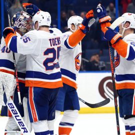 Dec 9, 2019; Tampa, FL, USA; New York Islanders goaltender Semyon Varlamov (40), defenseman Devon Toews (25), center Casey Cizikas (53) and teammates celebrate as they beat the Tampa Bay Lightning during the third period at Amalie Arena. Mandatory Credit: Kim Klement-USA TODAY Sports