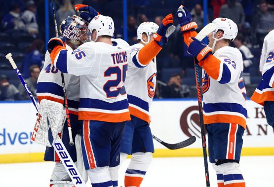 Dec 9, 2019; Tampa, FL, USA; New York Islanders goaltender Semyon Varlamov (40), defenseman Devon Toews (25), center Casey Cizikas (53) and teammates celebrate as they beat the Tampa Bay Lightning during the third period at Amalie Arena. Mandatory Credit: Kim Klement-USA TODAY Sports
